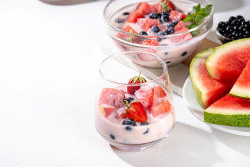 Subak Hwachae cocktail, Korean traditional watermelon punch salad drink, with a lot of fruit slices, with tapioca boba pearls, in glass and bowl for party, copy space
