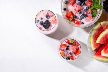 Subak Hwachae cocktail, Korean traditional watermelon punch salad drink, with a lot of fruit slices, with tapioca boba pearls, in glass and bowl for party, copy space