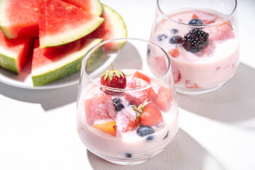 Subak Hwachae cocktail, Korean traditional watermelon punch salad drink, with a lot of fruit slices, with tapioca boba pearls, in glass and bowl for party, copy space