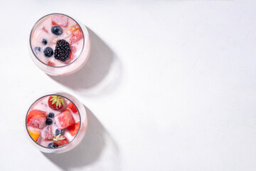 Subak Hwachae cocktail, Korean traditional watermelon punch salad drink, with a lot of fruit slices, with tapioca boba pearls, in glass and bowl for party, copy space