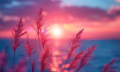 Vertical sunset over sea with soft purple and pink watercolor tones on grass stem in foreground.