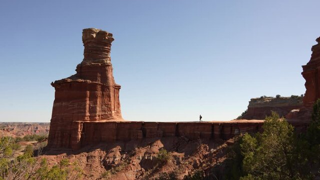 Hiker Walks Palo Duro Lighthouse. Caucasian Male Alone Epic Wide Explores Nature in Palo Duro Canyon State Park Wide Texas