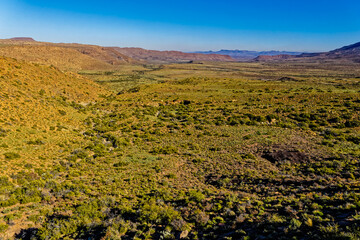 Landscape of Karoo mountains and valley with green vegetation after winter rains in the Karoo...