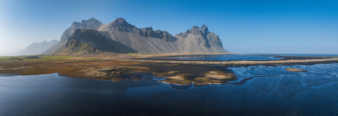 Stunning moody aerial landscape of mountain in Iceland. Impressive Colorful Seascape of Iceland. Wonderful picturesque Scene near Stokksnes cape and Vestrahorn Mountain