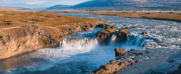 Aerial view of the powerful Godafoss waterfall on a sunny day in Northern Iceland. Beautiful Godafoss Waterfall in Northern Iceland.