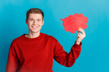 Photo of nice young man hold empty space bubble wear pullover isolated on blue color background
