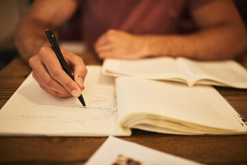 Man, student and notes with hand in cafe, notebook and university homework for ideas or assignment...