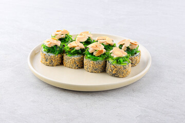 Traditional delicious fresh sushi roll set on a white background with reflection