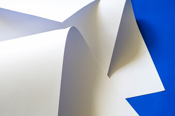Sheets of white paper on a blue background.