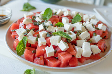 Watermelon salad with feta cheese, balsamic and pumpkin seeds. Delicious homemade summer food