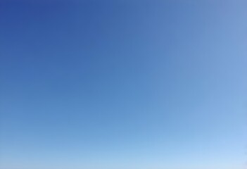 Clear blue sky, no clouds, among spoiled tree branches in winter time, cold, deep light blue, no people