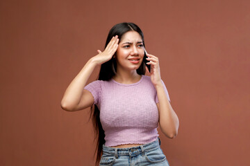 Frustrated Woman In Top And Jeans Talking On Mobile Phone And Looking Puzzled