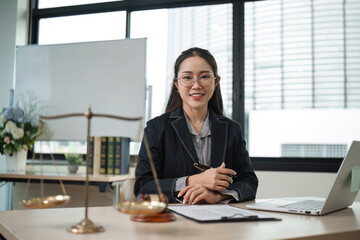 Professional Female Lawyer Reviewing Legal Documents in Modern Office Setting for Lawsuit Preparation