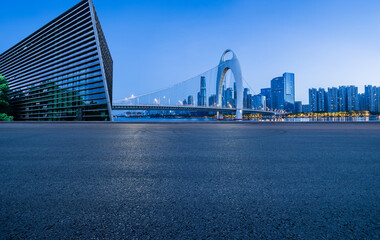 Asphalt road square and bridge with modern city buildings at night in Guangzhou. car advertising background.