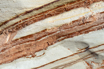 Natural rock texture background of multicolored sandstone rocks in the Almagreira beach in the Peniche area of the Center region of Portugal.