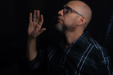 Portrait of bearded bald man in prescription glasses