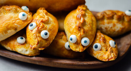 A tray of pastries with sweet eyes on them