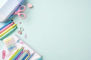 Colorful school stationery items on a light pastel background, including pencils, scissors, and paper clips