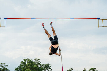 male athlete pole vault rear view at summer athletics games