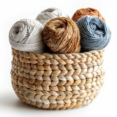 Obraz premium A beautiful still life of a wicker basket filled with colorful yarn. The basket is sitting on a white table. The image is warm and inviting.