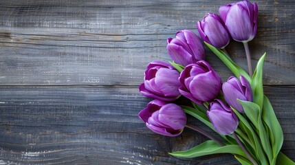 Several purple tulips displayed on a wooden surface