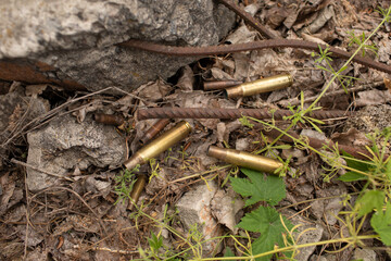 shot shell casings lie on the ground next to the metal fittings