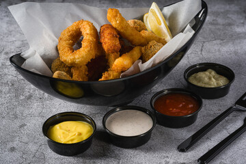 Deep fried squid, shrimp and mussels with sauces on the side