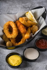 Deep fried squid, shrimp and mussels with sauces on the side
