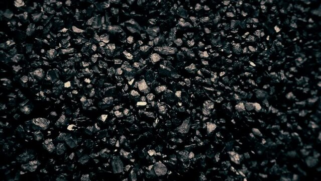 Close-up of a black sand surface moving.