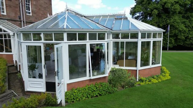 glass room veranda dining lunching dinner area castle hotel aerial panning shot drone