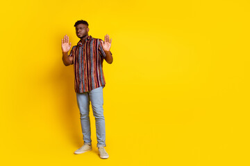 Full size photo of nice young man arms show stop enough empty space wear shirt isolated on yellow...