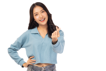 A joyful young asian woman in a casual blue outfit makes a heart gesture Her happy expression and relaxed pose convey warmth and friendliness.