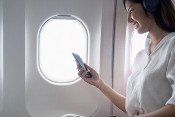 Modern Technology in Flight Travel, Passenger Using Smartphone on Airplane