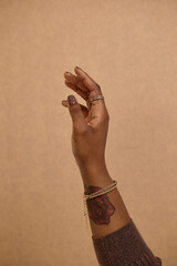 Vertical close up on female hand unrecognizable Black woman with dark brown nail and healthy skin,...