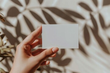 Elegance in Simplicity: Minimalist Business Card Mockup Held by a Hand with Subtle Studio Lighting and Subsurface Scattering Effects