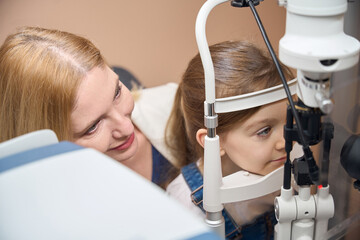 Girls eyes are checked using special equipment