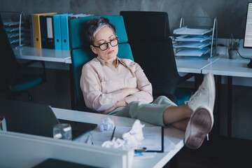 Photo of tired bored senior lady secretary wear formal shirt sleeping indoors workshop workstation...