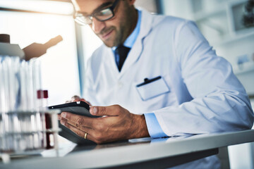 Healthcare, scientist and man with tablet in laboratory for research, review data and reading experiment test results. Male researcher, digital and report info, medical and pharmaceutical vaccine