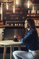 Woman, coffee and thinking by table in cafe with weekend break, calm morning and ideas for espresso order. Female customer, green tea drink and daydreaming with happy thoughts, relax and alone time