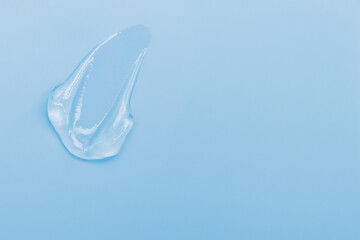 Gel smears cosmetic texture on blue background with space for text