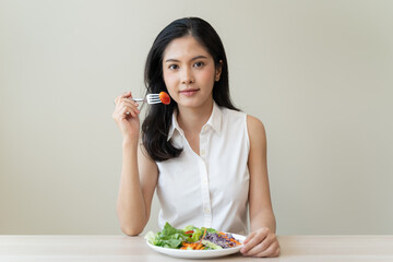 Diet, Dieting asian young woman or girl use fork at broccoli on mix vegetables, green salad bowl, eat food is low fat good health. Nutritionist female, Weight loss for healthy person.