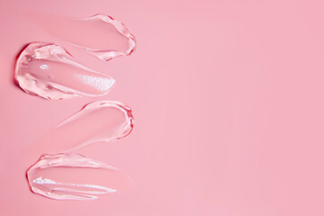 Gel smears cosmetic texture on pink background with space for text