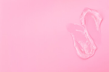 Gel smears cosmetic texture on pink background with space for text