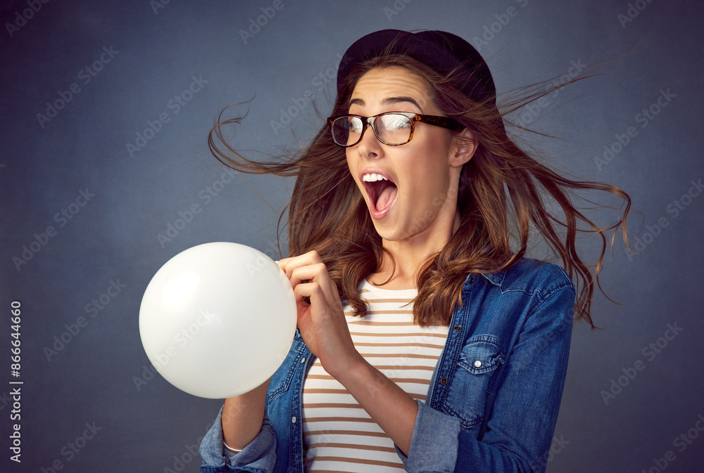 Canvas Prints Surprise, woman and blowing balloon with air in studio for party, celebration or event decor. Funny girl, helium inflatable and model shocked with wind in hair, wow or excited isolated on background