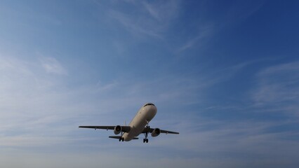Airplane in the sky at sunset. Air transportation.  Travel. Airplane Takes Off Against the Background of Blue Sky. 