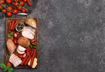 deli meats sausage on a wooden board for appetizer