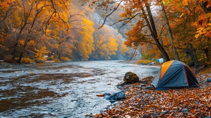 A peaceful riverside campsite with a view of a gently flowing river and vibrant autumn foliage in the background.