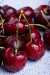 Fresh red cherries fruit. Fresh organic berries with leaves macro. Large collection of fresh red cherries. Ripe cherries background. Lot of red ripe cherries close up with water drops.