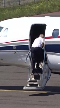 Executive Jet with Pilot boarding the airplane at Small Airport (Business   private jet   corporate jet)