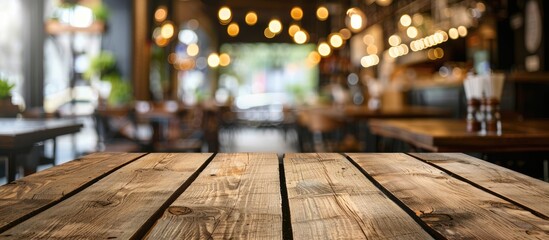 Empty brown wooden table with blurred Coffee shop or restaurant background for photomontage or product display